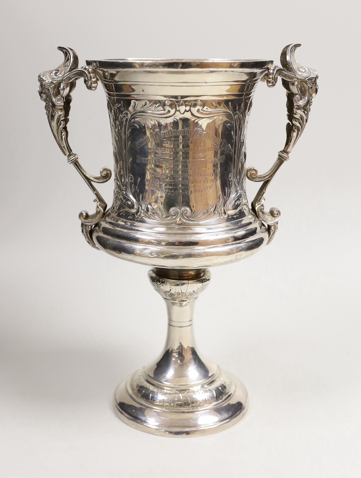 FOOTBALL INTEREST- A late Victorian silver two handled presentation trophy cup, embossed with footballers and inscribed ' Vernon Wentworth Challenge Cup, presented top The Brighton Football Association by Bruce c. Vernon